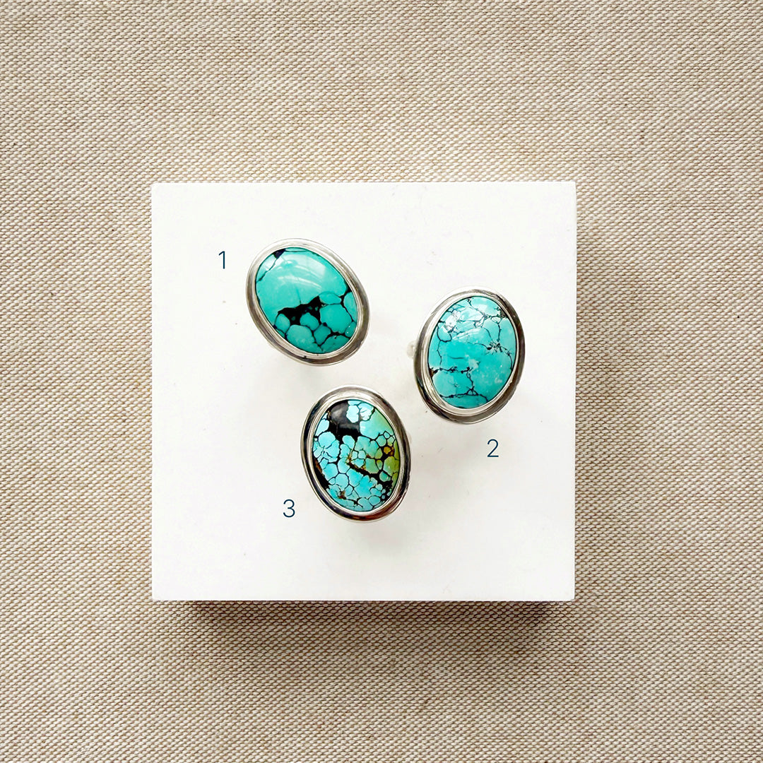 Nevada turquoise rings on a white card numbered 1 through 3.