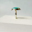 Side view of Nevada turquoise ring on a white background