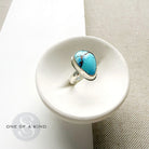 One of a kind Golden Hills Turquoise silver ring in a white dish