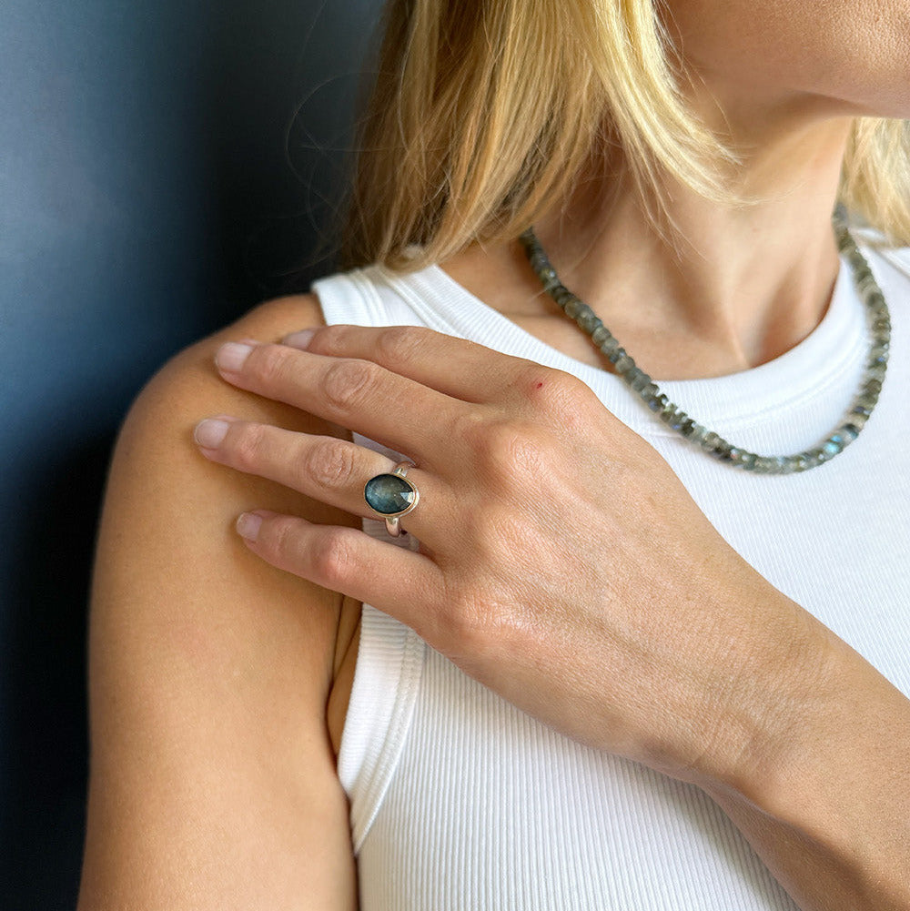 Model wearing an oval London blue topaz gemstone ring