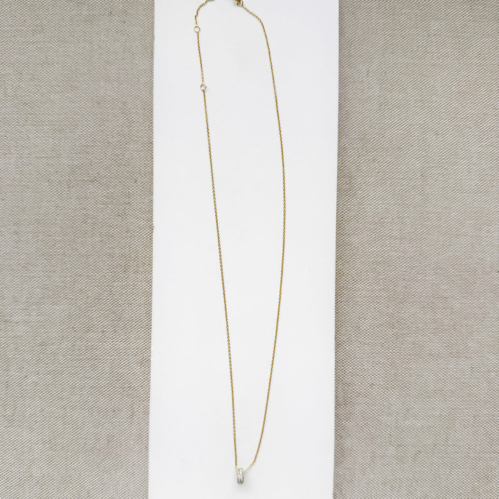 Diamond pave wheel charm on a gold chain