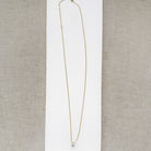 Diamond pave wheel charm on a gold chain