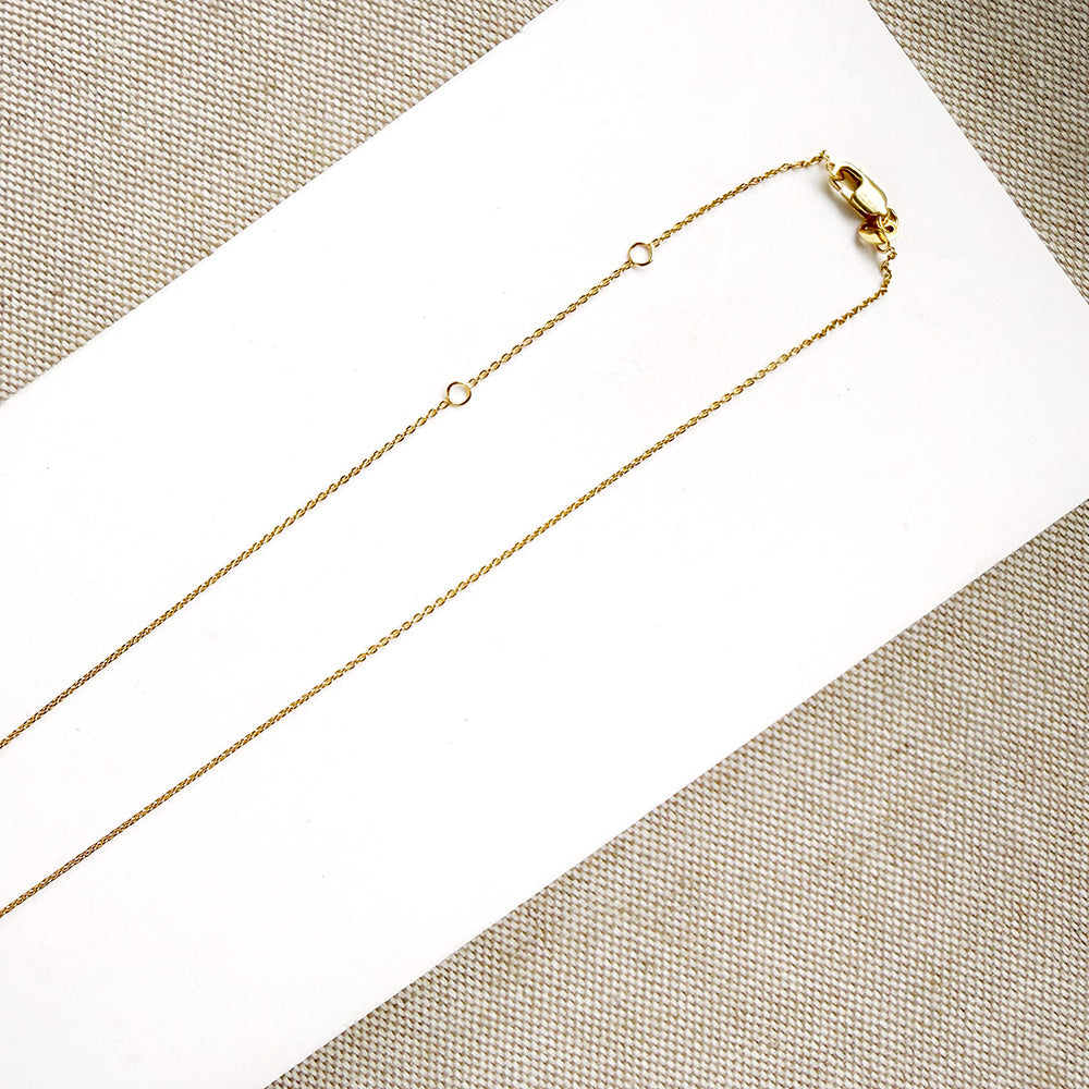 Clasp detail of Diamond pave wheel charm on a gold chain
