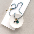 Pearl necklace in a dish with pearl charm