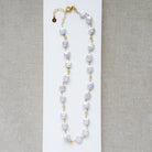 Coin pearl necklace with citrine gems on a white background
