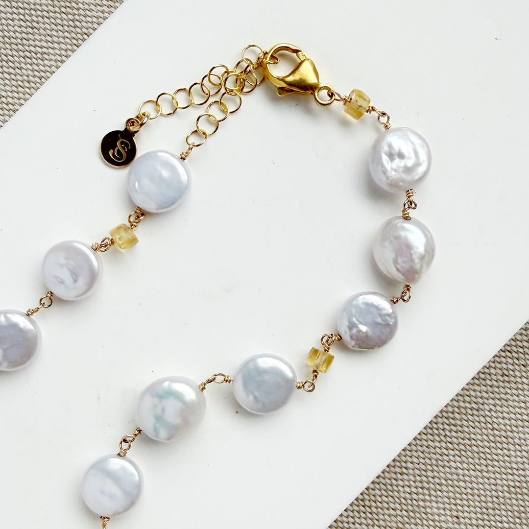 Clasp detail of coin pearl necklace with citrine gems