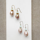 Pink pearl drop earrings on a white background