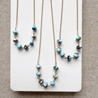 Necklaces featuring Golden Hill turquoise beads on a white card with a beige background