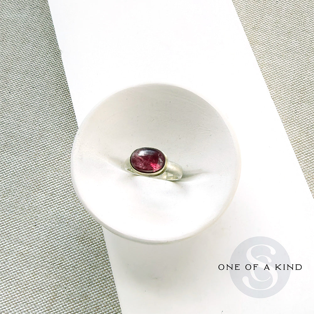 Pink tourmaline mixed metal ring in a dish