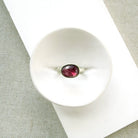 Pink tourmaline mixed metal ring in a dish