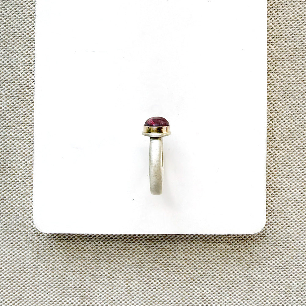 Pink tourmaline mixed metal ring on a white background
