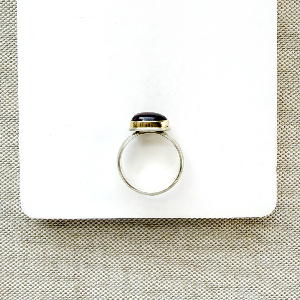 Pink tourmaline mixed metal ring on a white background