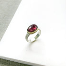 Pink tourmaline mixed metal ring on a white background