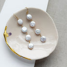 Coin pearl statement earrings in a pale pink dish