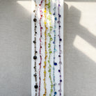 Set of colorful gemstone necklaces on a white backgrounds