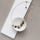 Necklace with multicolored gemstones on a white card