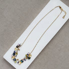 Necklace with multicolored gemstones on a white card