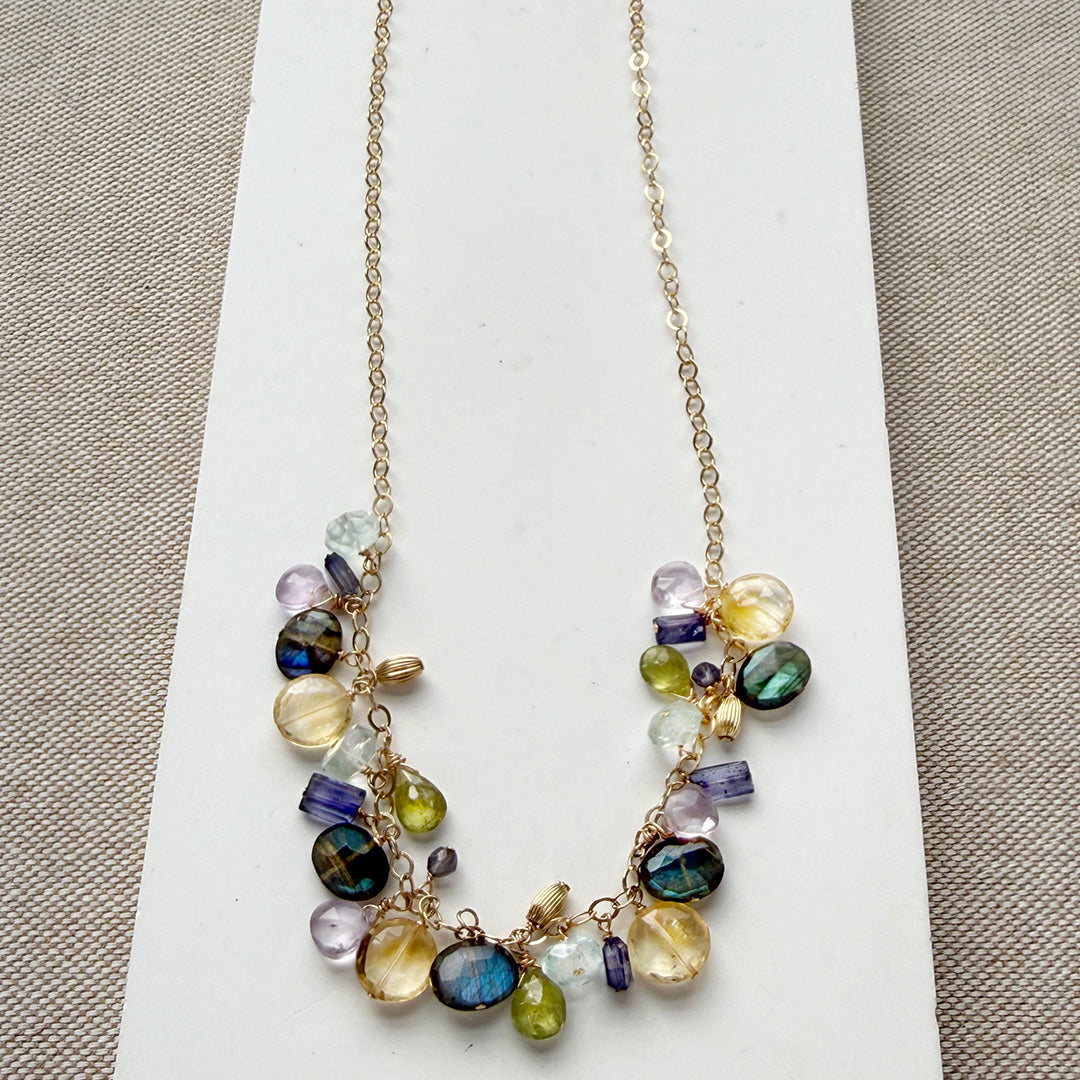Necklace with multicolored gemstones on a white card