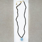 Smoky brown quartz knotted necklace with blue chalcedony carved pendant