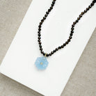 Smoky brown quartz knotted necklace with blue chalcedony carved pendant