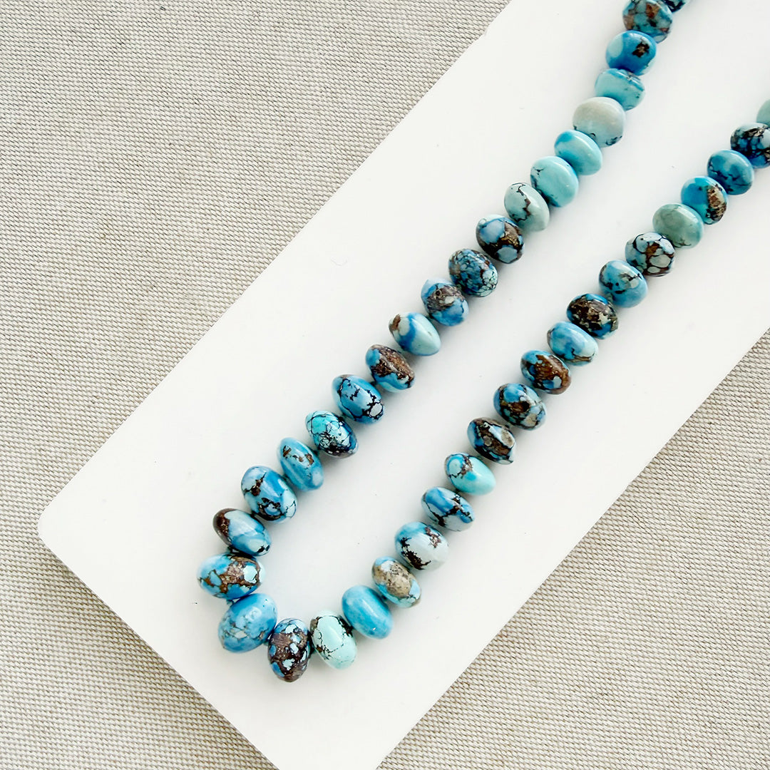 Golden Hill turquoise beaded necklace on a white dish with a neutral background 