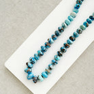 Golden Hill turquoise beaded necklace on a white dish with a neutral background 