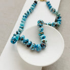 Golden Hill turquoise beaded necklace on a white dish with a neutral background 