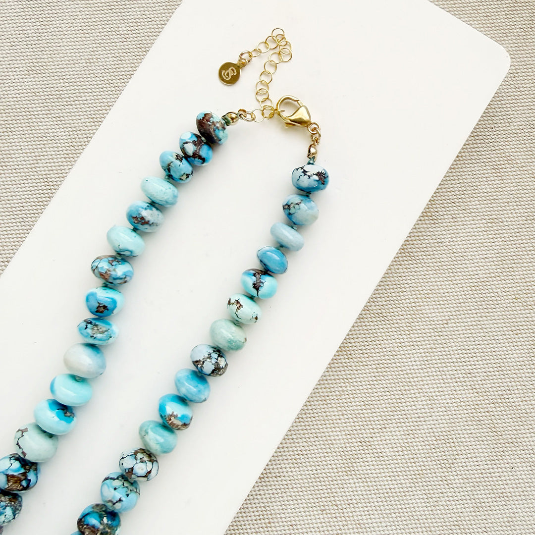 Golden Hill turquoise beaded necklace on a white dish with a neutral background 