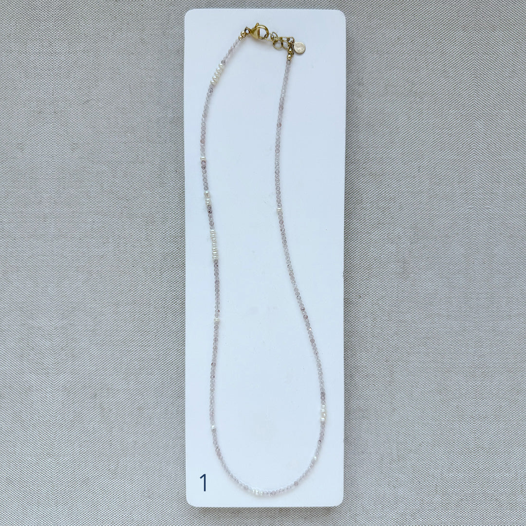 Option 1 Rose quartz and pearl necklace on a white card with a gray background