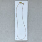 Option 1 Rose quartz and pearl necklace on a white card with a gray background