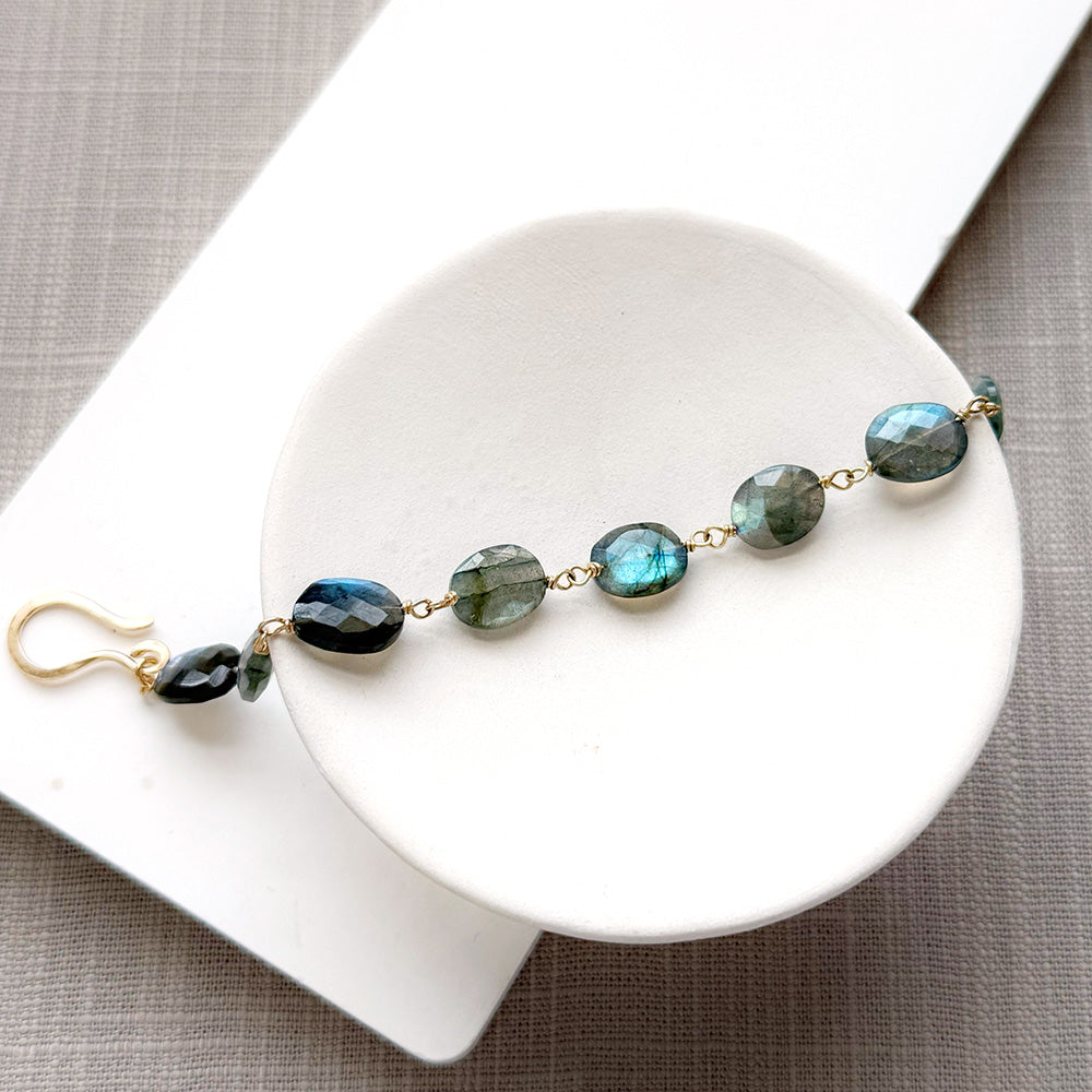 Labradorite bracelet with a handmade clasp in a white dish