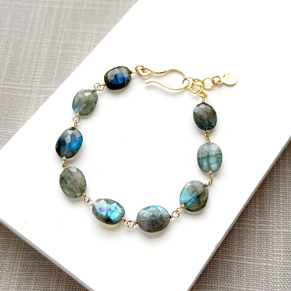 Labradorite bracelet with a handmade clasp in a white dish