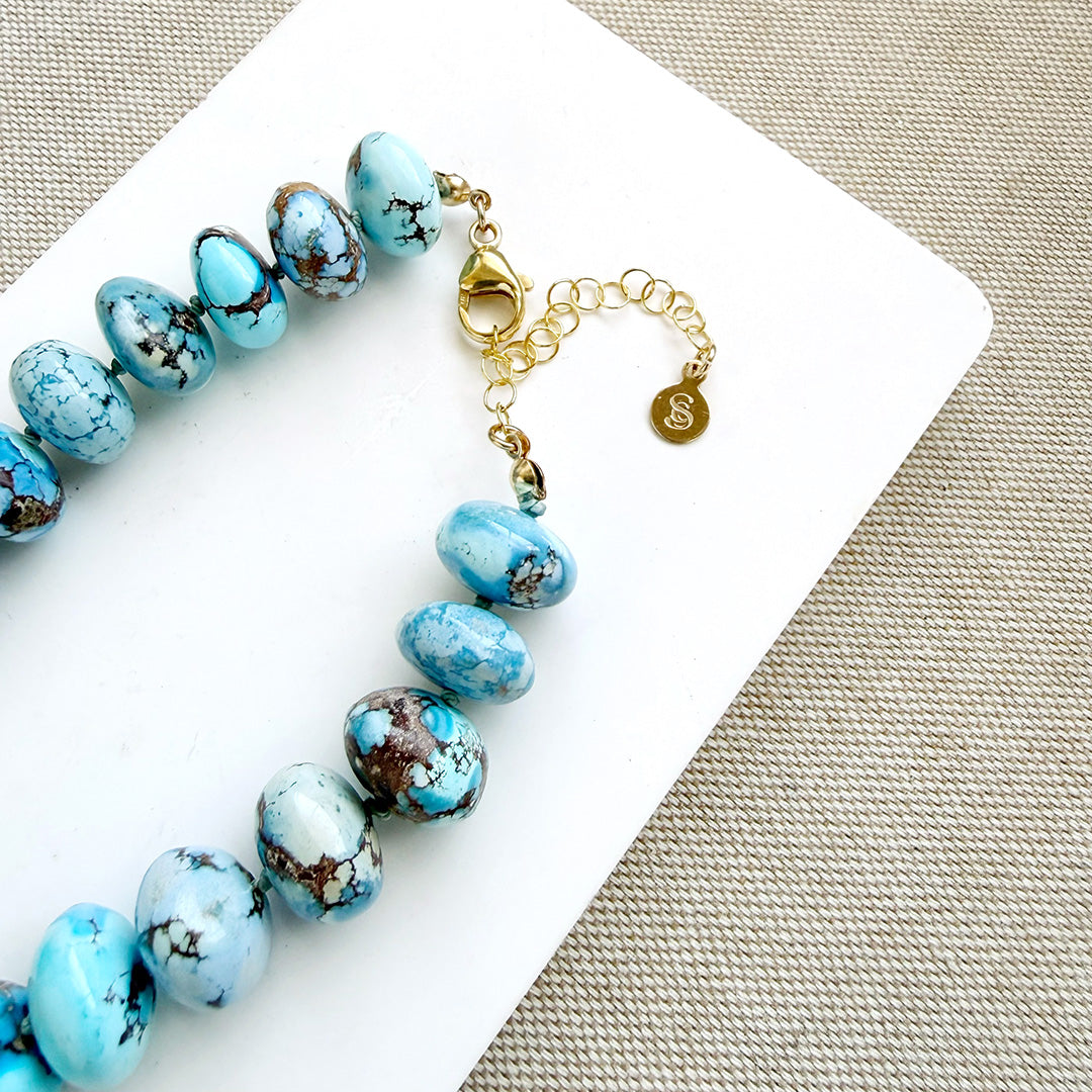 Clasp detail of golden hills turquoise necklace with 12.5 - 14 mm size beads on a white background