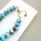 Clasp detail of golden hills turquoise necklace with 12.5 - 14 mm size beads on a white background