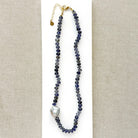 Knotted iolite gemstone necklace with gray baroque pearl on a white card