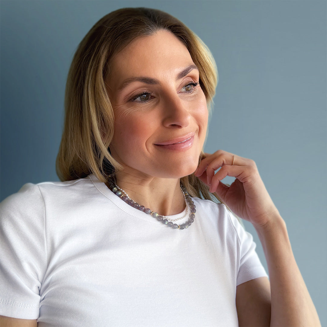 Blonde woman wearing round labradorite bead necklace