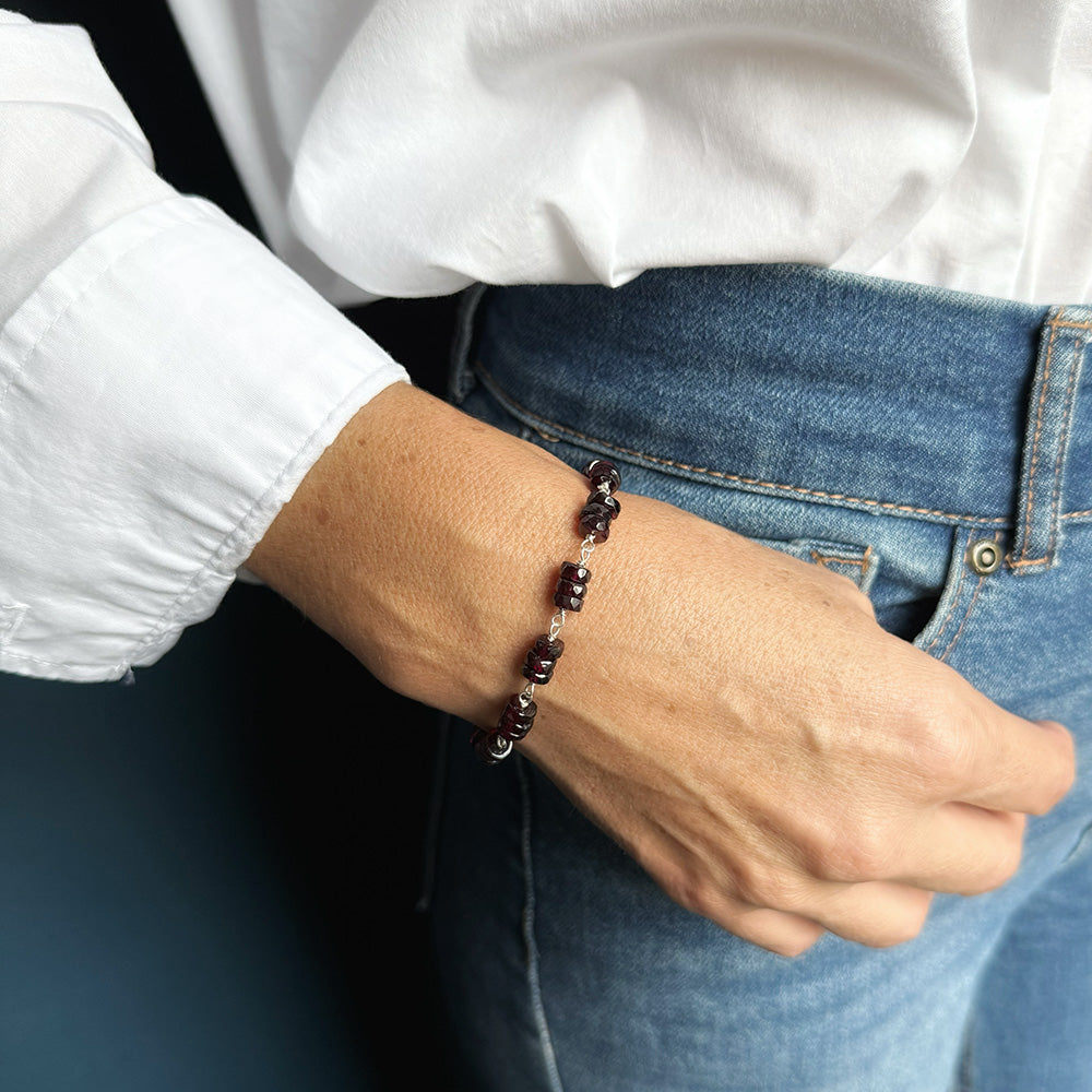 Woman wearing Sienna garnet bracelet with jeans and a white shirt