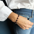 Woman wearing Sienna garnet bracelet with jeans and a white shirt