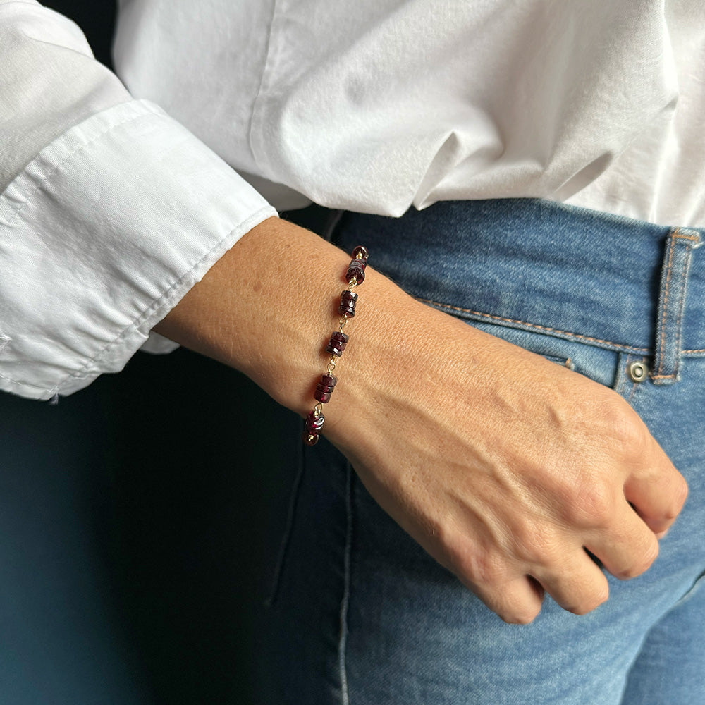 Woman wearing Sienna garnet bracelet with jeans and a white shirt