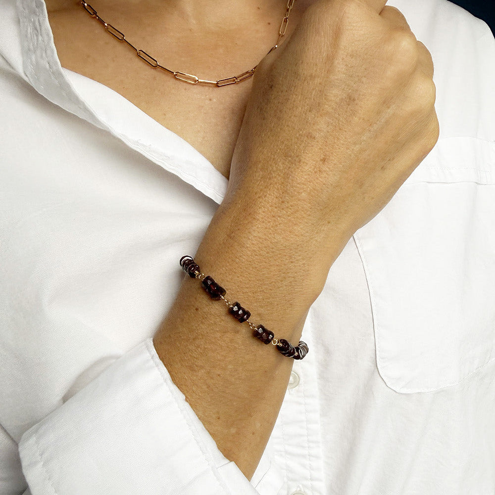 Woman wearing Sienna garnet bracelet with jeans and a white shirt