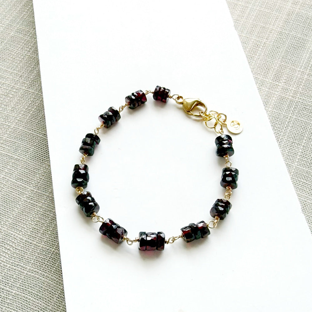 Sienna garnet bracelet on a white plate