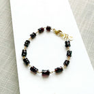 Sienna garnet bracelet on a white plate