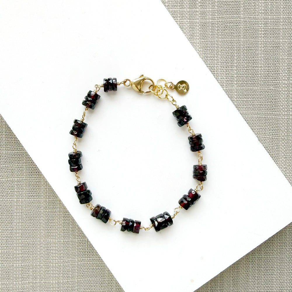 Sienna garnet bracelet on a white plate