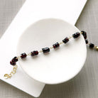 Sienna garnet bracelet in a white dish