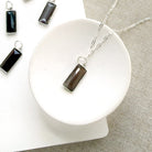 Rectangular bezel set coffee moonstone charm in silver