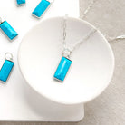 Rectangular bezel set blue howlite charm in silver