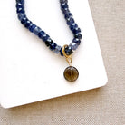 Round smoky quartz charm on a gemstone necklace