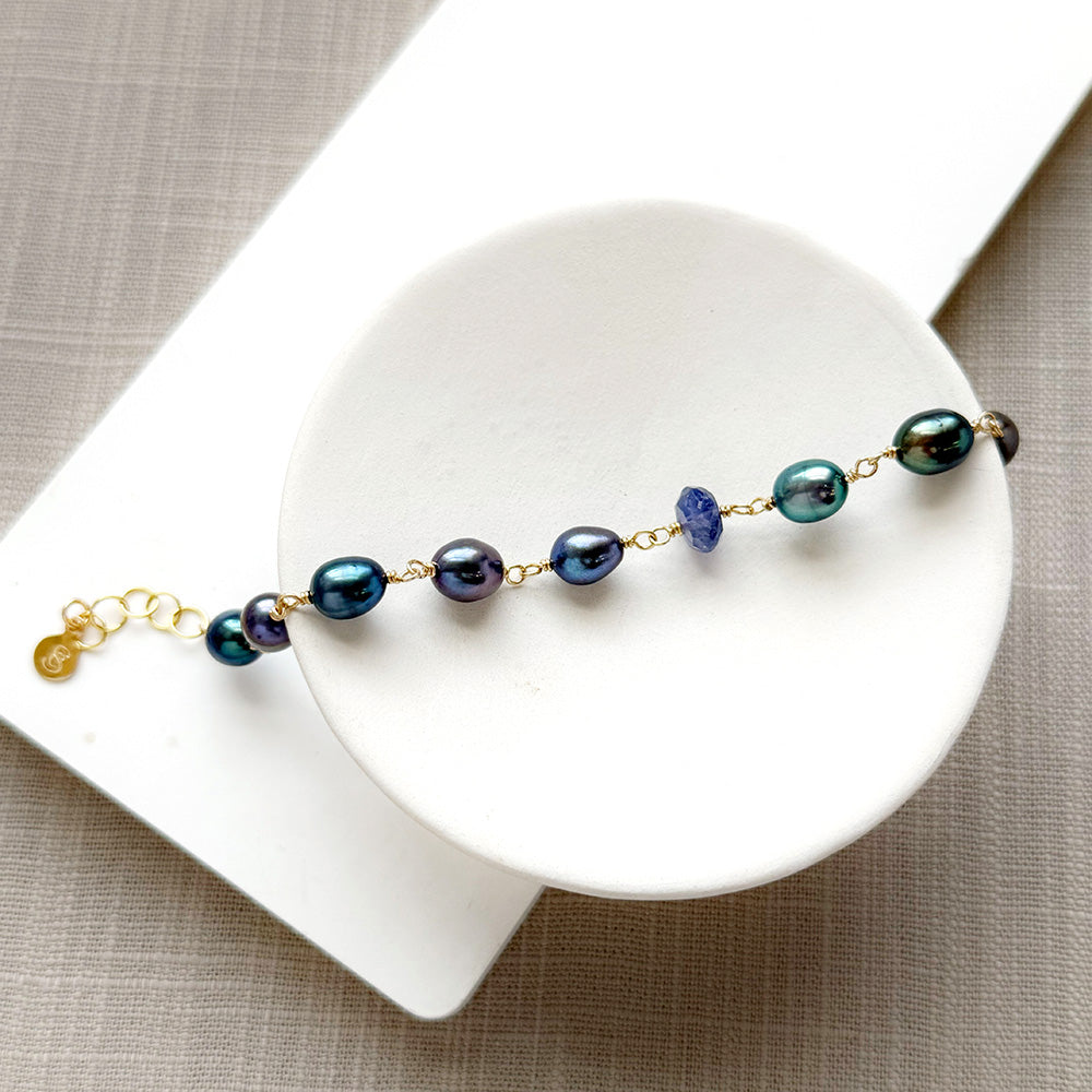 Peacock pearl and iolite bracelet in a white dish