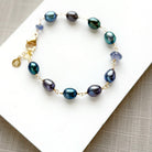 Peacock pearl and iolite bracelet on a white dish