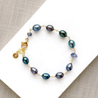 Peacock pearl and iolite bracelet on a white dish